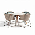 Woven rattan dining set with four chairs and rectangular table for outdoor use